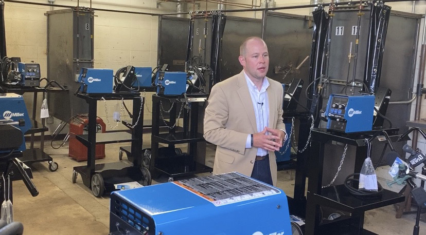 LTC President Paul Carlsen speaks among the 13 newly installed welding bays at Kiel High School.