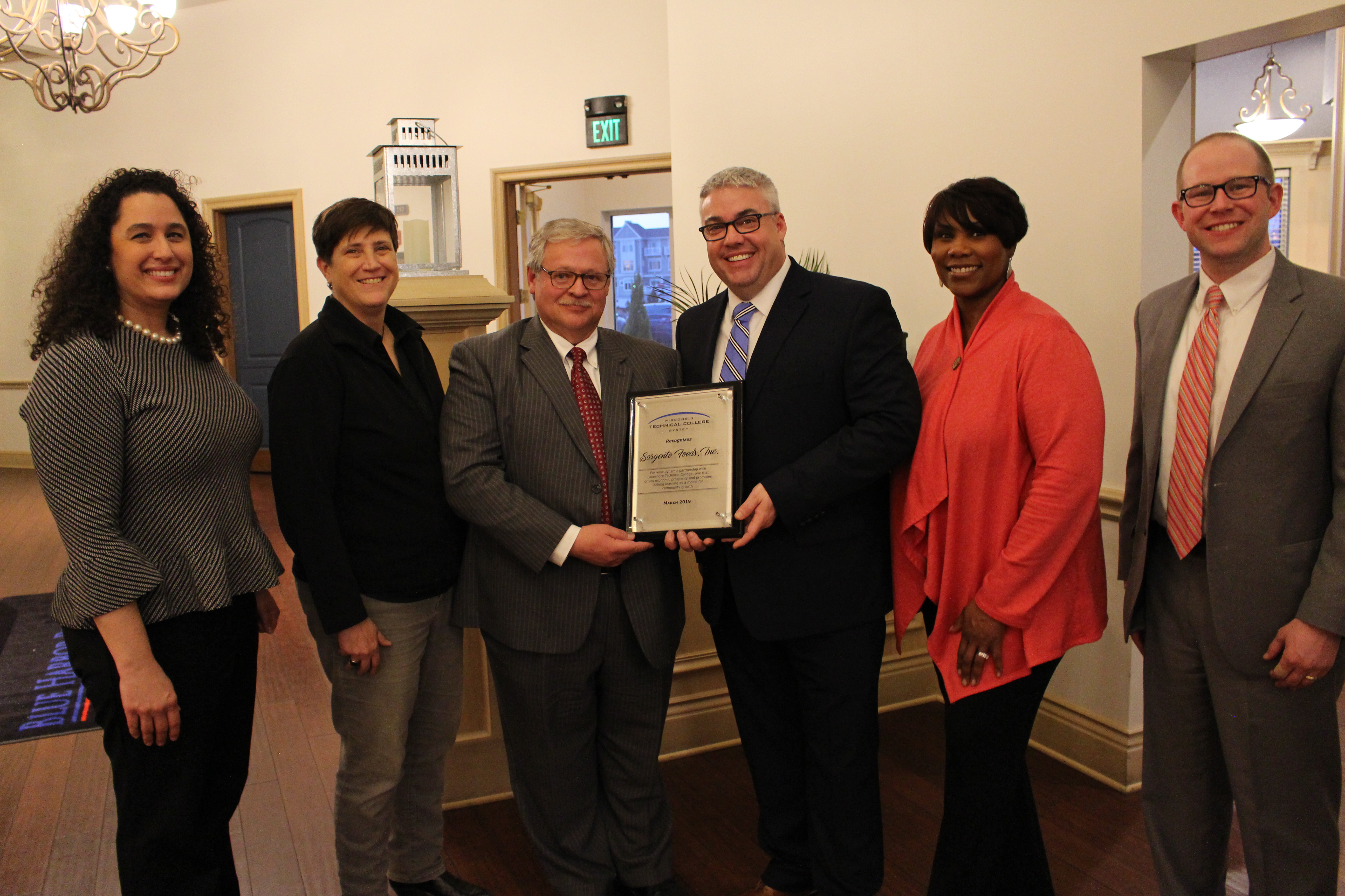 Sargento Executive Vice President of Operations Mike McEvoy (third from right) accepts the Futuremaker Partner award from WTCS Board President S. Mark Tyler. Also pictured from left are Sargento Workforce Development Liaison Anne Troka, Wisconsin Technical College System President Dr. Morna K. Foy, Sargento Director of Corporate Communications Portia Young, and Lakeshore Technical College President Paul Carlsen. [WTCS Photo]